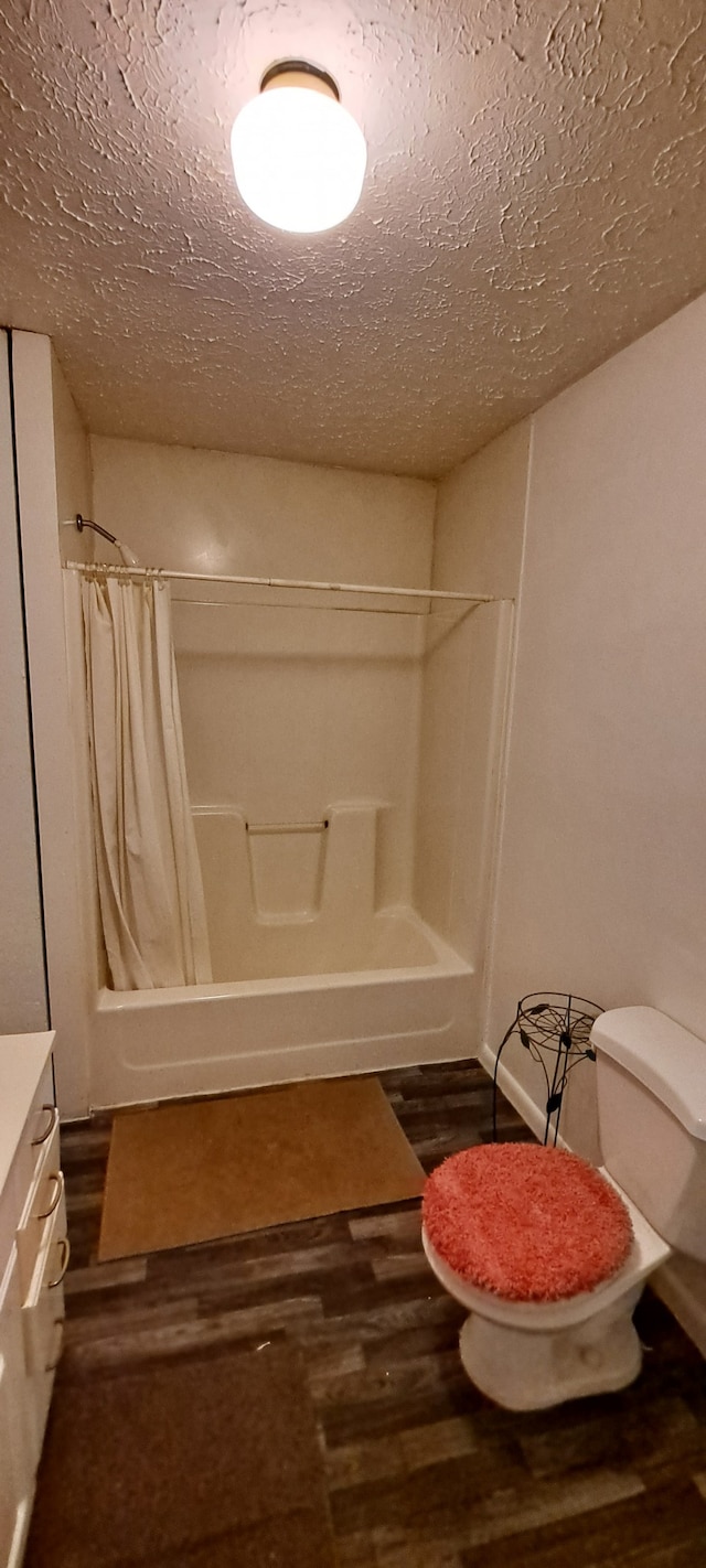 full bathroom featuring vanity, wood-type flooring, toilet, and shower / bathtub combination with curtain