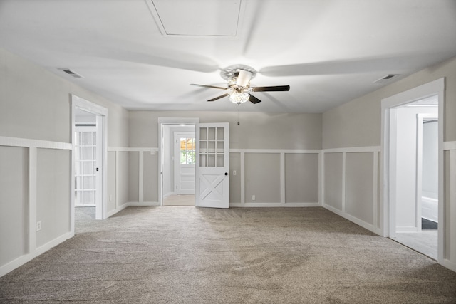 spare room featuring ceiling fan, light colored carpet, and french doors