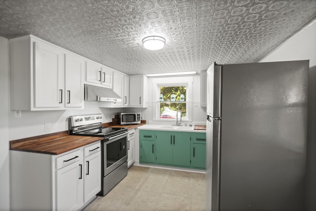 kitchen featuring sink, stainless steel appliances, butcher block countertops, white cabinetry, and green cabinetry