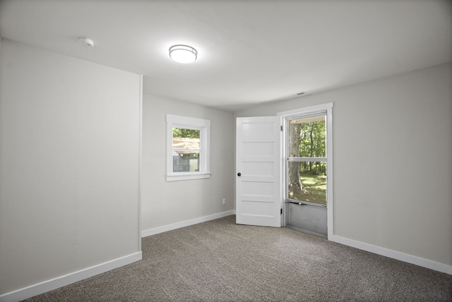 empty room featuring dark colored carpet