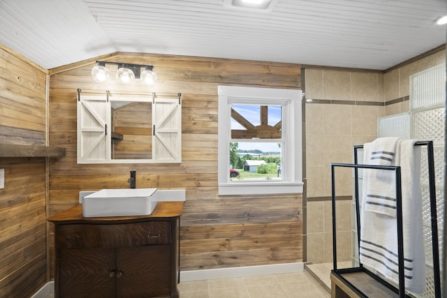 bathroom featuring wooden walls, an enclosed shower, tile floors, vaulted ceiling, and large vanity