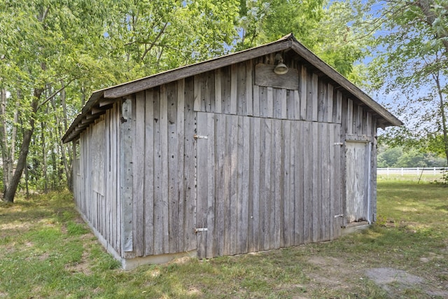 view of outdoor structure featuring a lawn