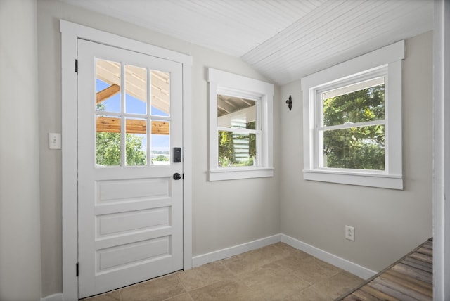 entryway featuring lofted ceiling and light tile floors