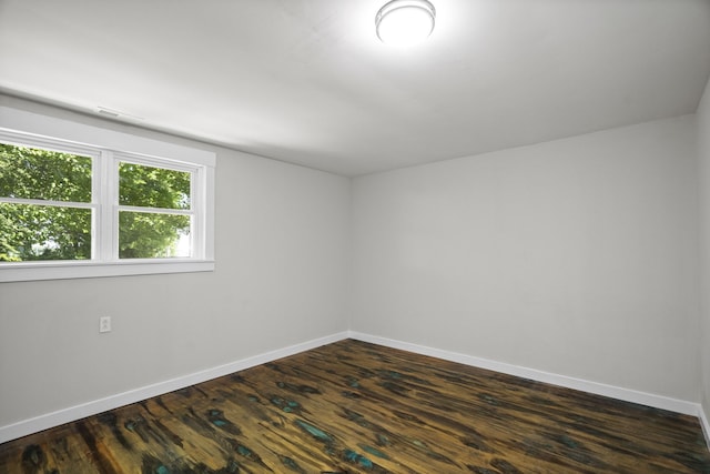 spare room featuring dark wood-type flooring