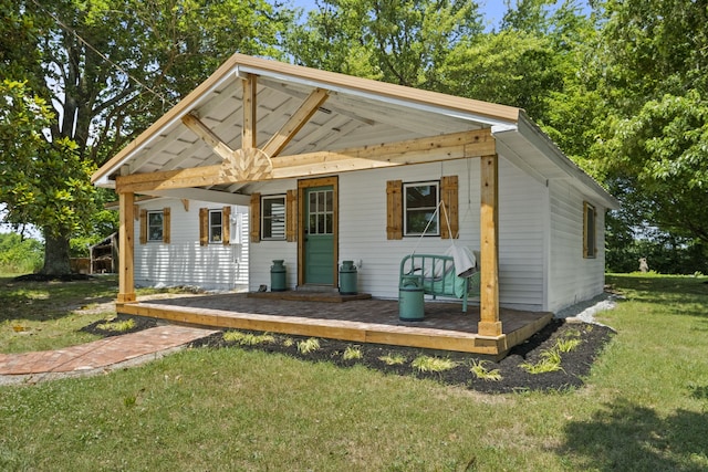 view of front facade with a deck and a front lawn