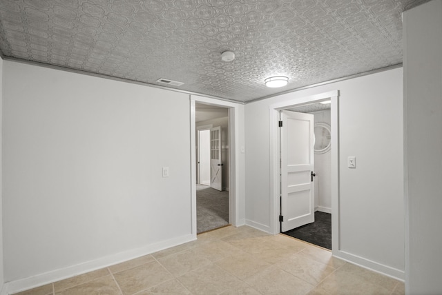 unfurnished bedroom with light tile floors