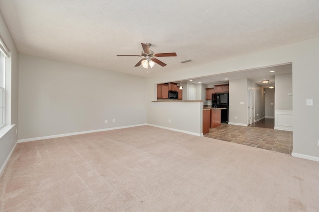 unfurnished living room with carpet flooring and ceiling fan