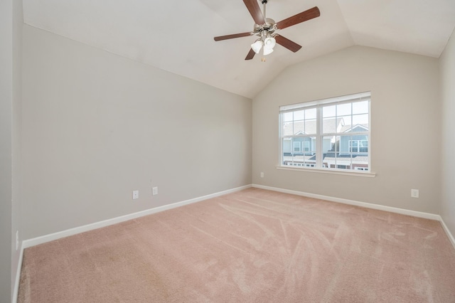 carpeted spare room with ceiling fan and lofted ceiling