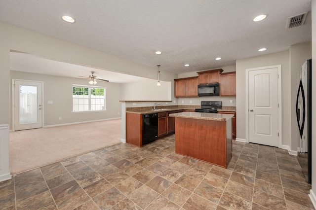 kitchen with ceiling fan, dark tile floors, and black appliances