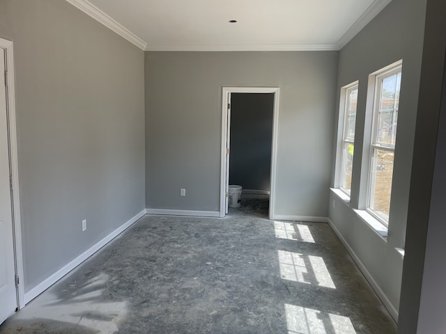 unfurnished room with plenty of natural light and crown molding