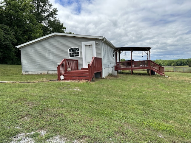 rear view of property featuring a deck, central AC, and a lawn