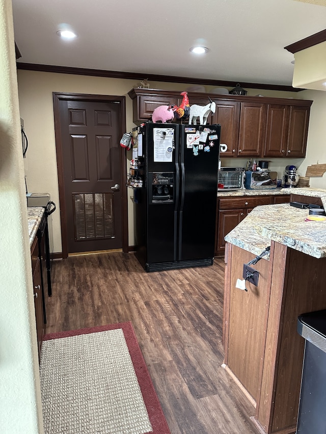 72 Golden Hollow Rd, Kelso, TN 37348 - kitchen featuring black fridge, ornamental molding, dark brown cabinets, dark hardwood / wood-style floors, and light stone counters
