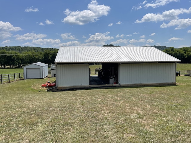 72 Golden Hollow Rd, Kelso, TN 37348 - view of outdoor structure with a lawn and a garage