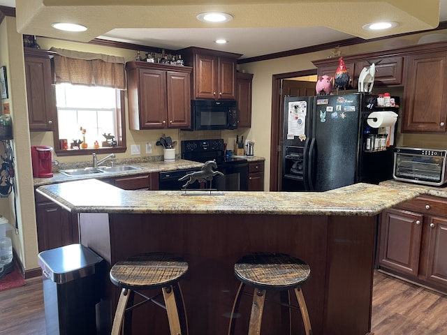 72 Golden Hollow Rd, Kelso, TN 37348 - kitchen with a kitchen bar, dark hardwood / wood-style flooring, black appliances, and sink