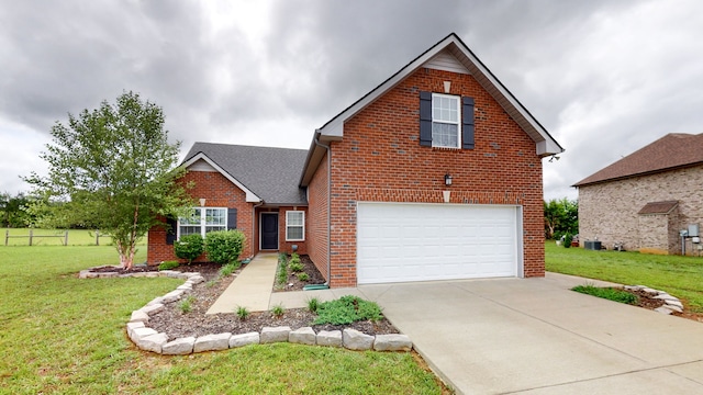 view of property featuring a front yard and a garage