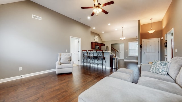 living room with high vaulted ceiling, dark hardwood / wood-style floors, and ceiling fan with notable chandelier