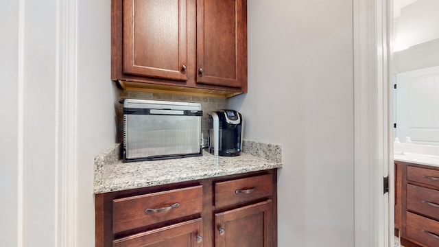 kitchen with light stone counters and tasteful backsplash