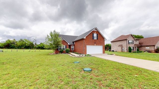 view of front of property featuring a front yard and a garage