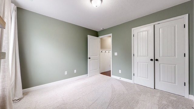 unfurnished bedroom with a closet and light carpet