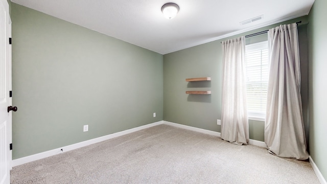 empty room featuring light carpet