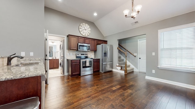 kitchen with decorative light fixtures, an inviting chandelier, appliances with stainless steel finishes, dark hardwood / wood-style floors, and sink