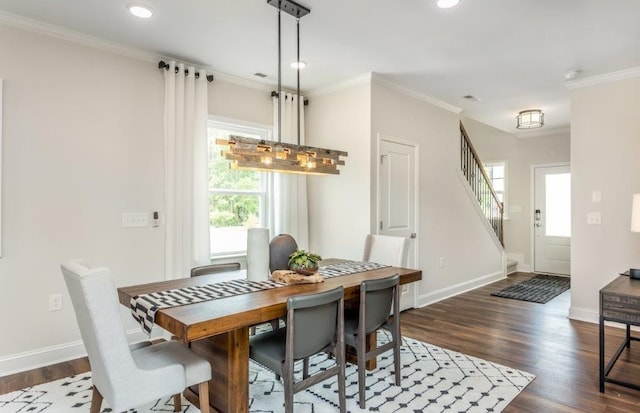 dining space featuring crown molding, dark hardwood / wood-style floors, and a wealth of natural light