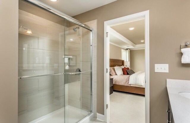 bathroom featuring vanity and a shower with shower door