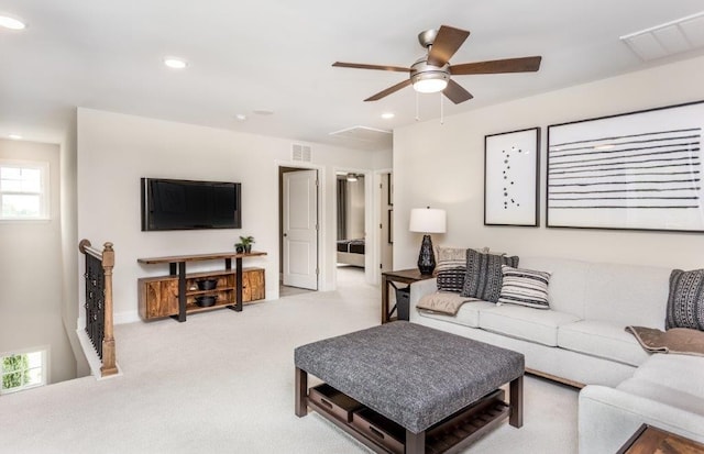 carpeted living room with ceiling fan and a healthy amount of sunlight