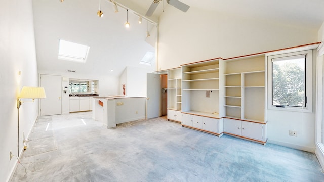 interior space with light carpet, vaulted ceiling, ceiling fan, and rail lighting