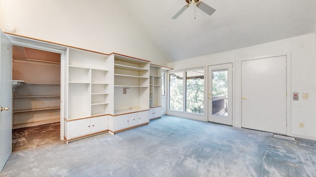 interior space with a walk in closet, ceiling fan, high vaulted ceiling, access to outside, and light colored carpet