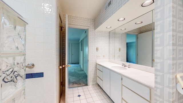 bathroom featuring tile walls, tile floors, and oversized vanity