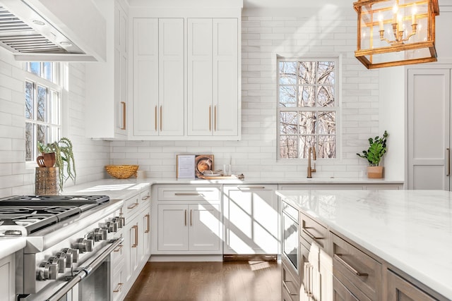 kitchen featuring custom range hood, dark wood-type flooring, an inviting chandelier, white cabinetry, and high end stainless steel range oven