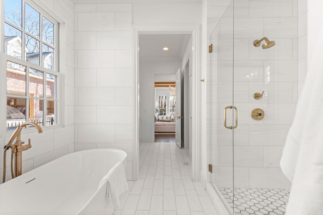 bathroom with tile flooring, separate shower and tub, and tile walls