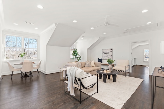 living room featuring ceiling fan, dark wood-type flooring, a healthy amount of sunlight, and ornamental molding