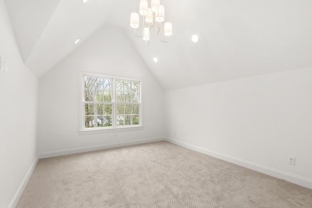 bonus room with light carpet, lofted ceiling, and a chandelier