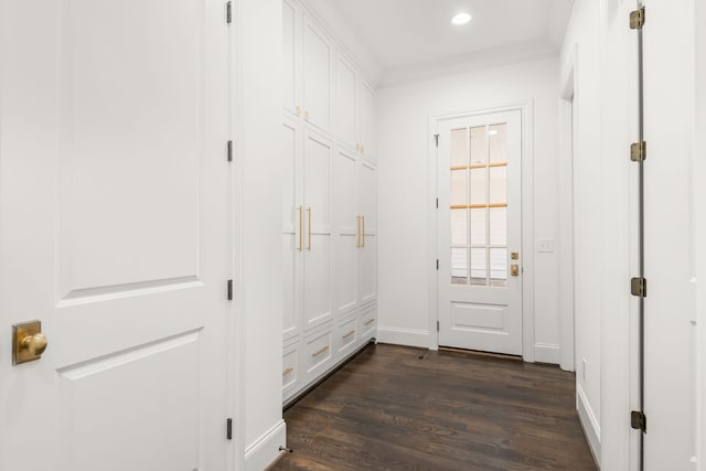 interior space with ornamental molding and dark hardwood / wood-style flooring