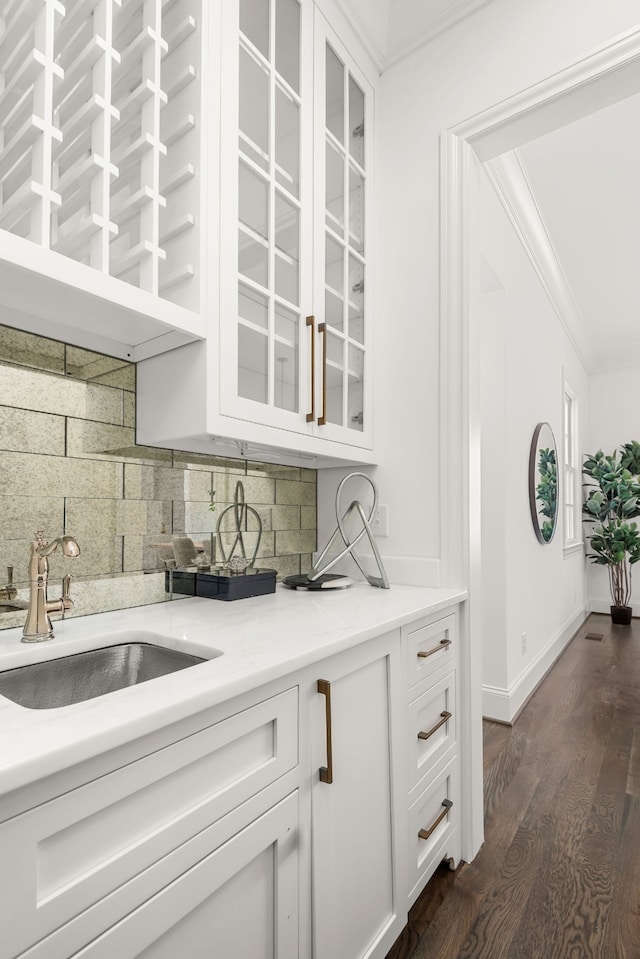 kitchen with crown molding, sink, dark hardwood / wood-style floors, and white cabinets