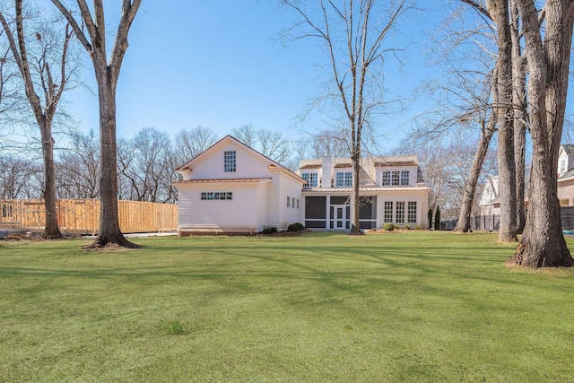 rear view of house featuring a yard