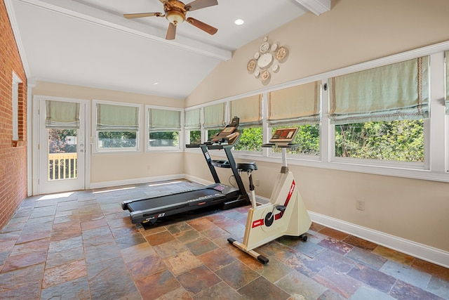 exercise area featuring dark tile floors, lofted ceiling, and ceiling fan