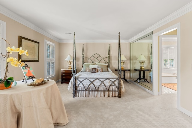 bedroom with ornamental molding and light colored carpet