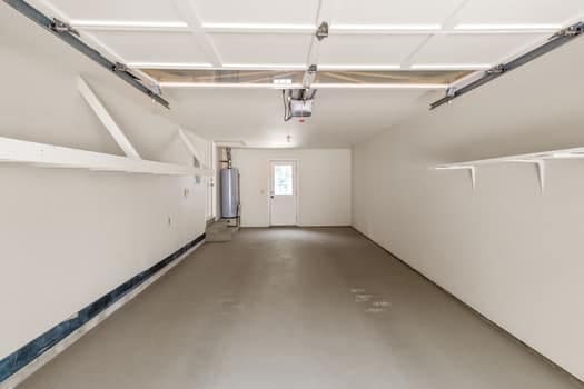 garage with water heater and a garage door opener