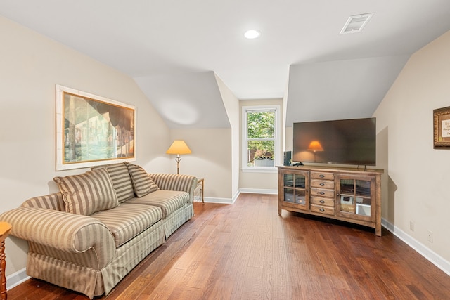 living room with dark hardwood / wood-style flooring and lofted ceiling