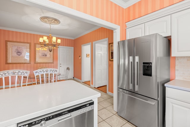 kitchen featuring stainless steel appliances, light tile floors, a chandelier, crown molding, and white cabinets