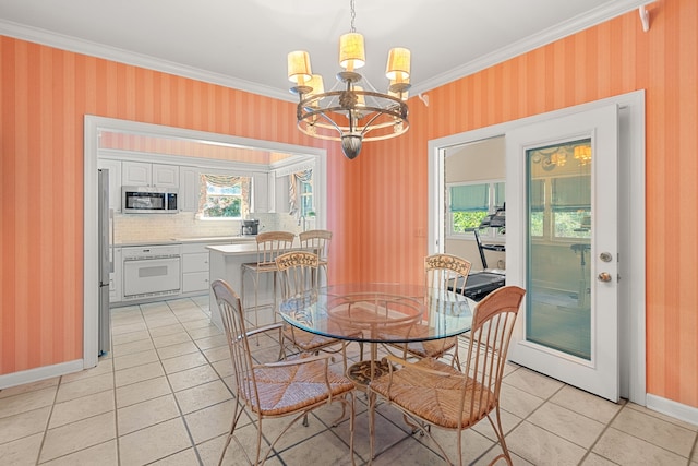 dining room with crown molding, a chandelier, and light tile floors