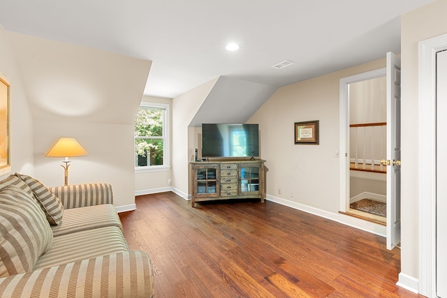 living room with lofted ceiling and dark hardwood / wood-style floors