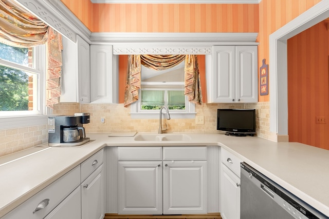 kitchen with backsplash, a healthy amount of sunlight, and white cabinets