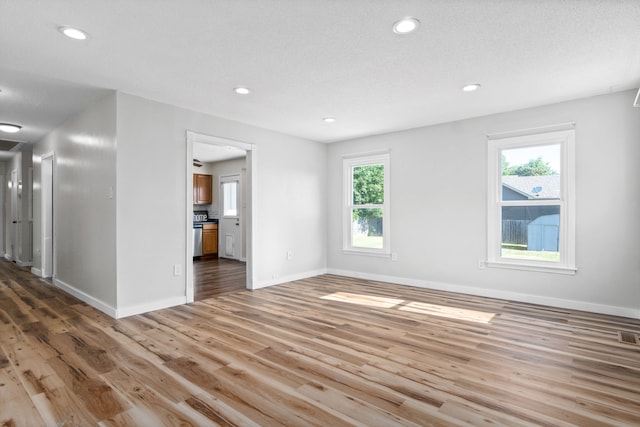 empty room with hardwood / wood-style flooring