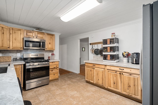 kitchen with appliances with stainless steel finishes, crown molding, tasteful backsplash, and light tile floors