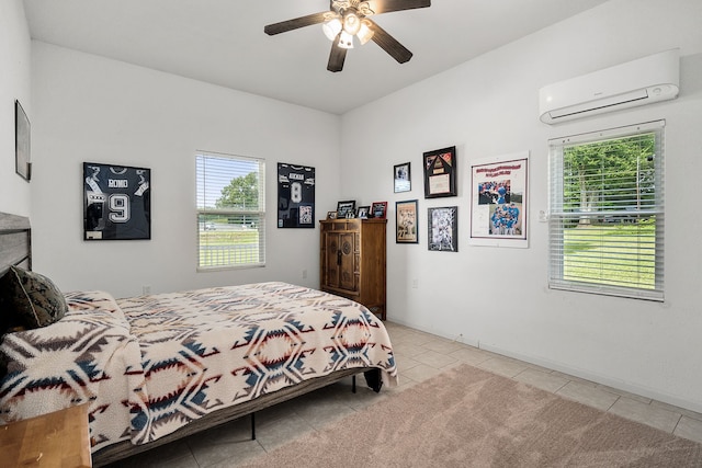 bedroom with a wall mounted AC, light tile floors, multiple windows, and ceiling fan