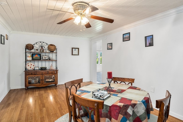 dining area featuring crown molding, light hardwood / wood-style floors, ceiling fan, and wooden ceiling